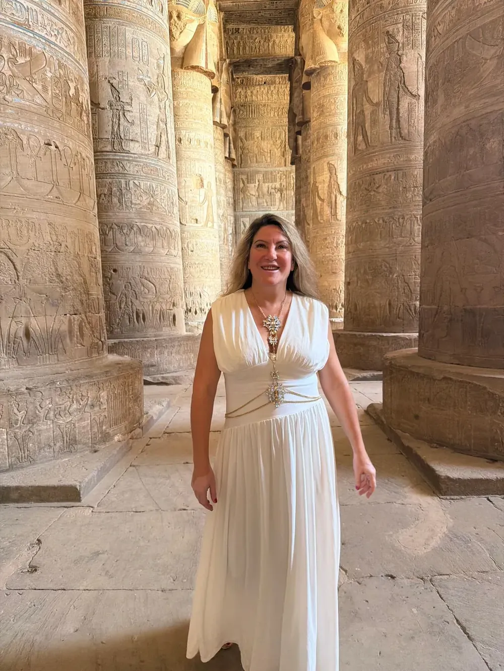 Zhivka Hristova in a white dress among ancient temple columns in Egypt